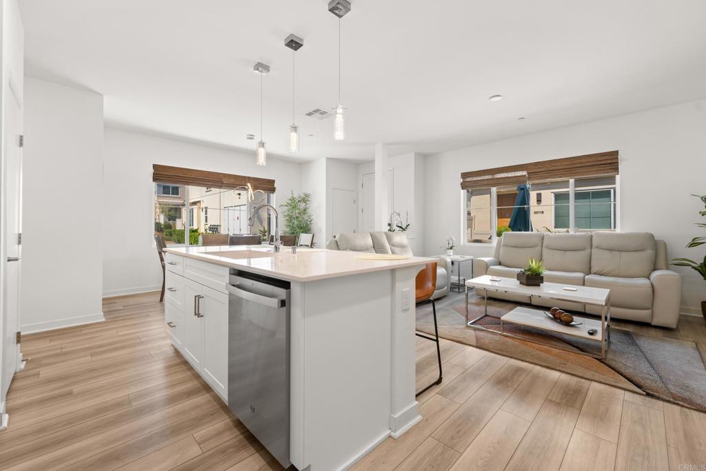 35115 Crop Place Fallbrook, CA 92028 - Photo 11 of 41 a living room with stainless steel appliances kitchen island hardwood floor and a window