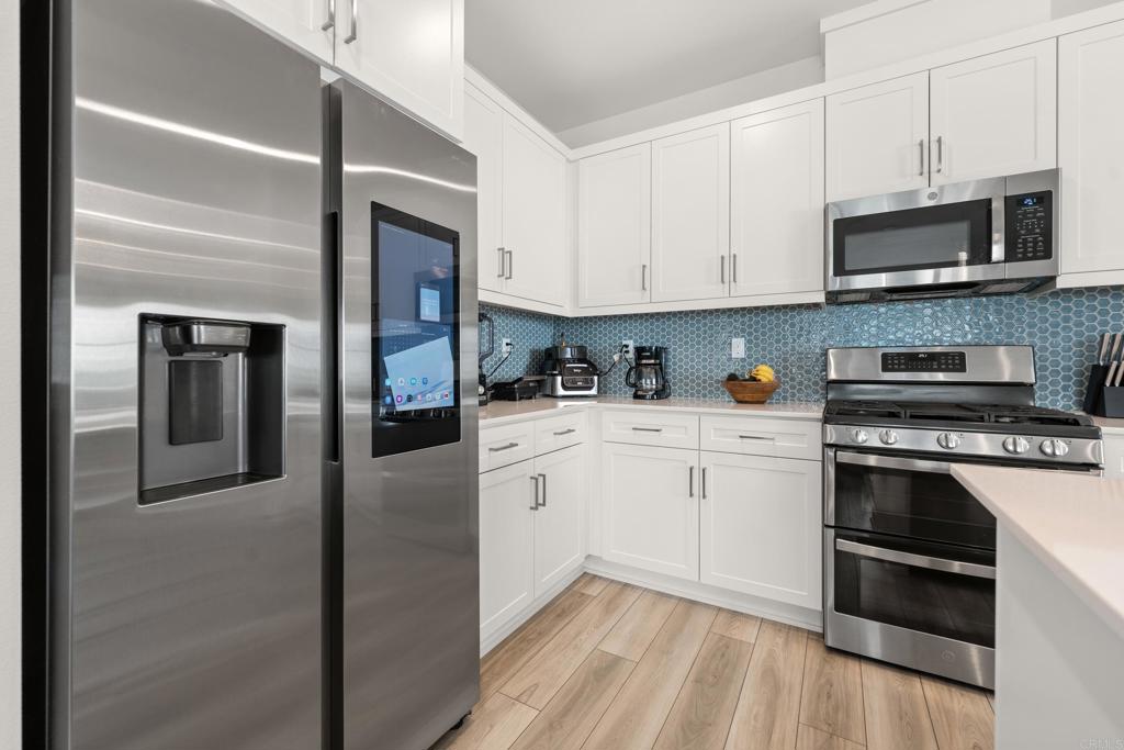 35115 Crop Place Fallbrook, CA 92028 - Photo 13 of 41 a kitchen with cabinets stainless steel appliances and sink