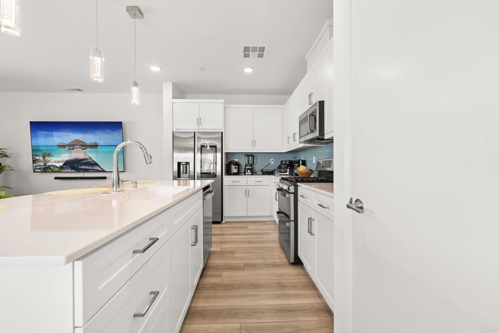 35115 Crop Place Fallbrook, CA 92028 - Photo 9 of 41 a kitchen with stainless steel appliances granite countertop a sink and cabinets