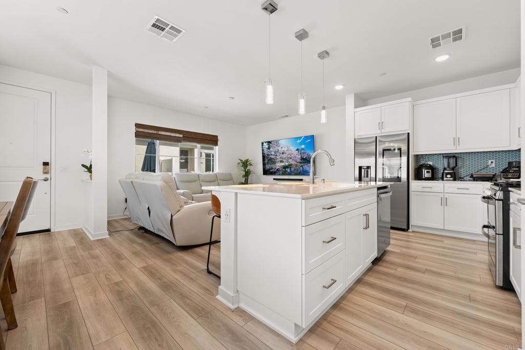 35115 Crop Place Fallbrook, CA 92028 - Photo 10 of 41 a kitchen with white cabinets and white appliances