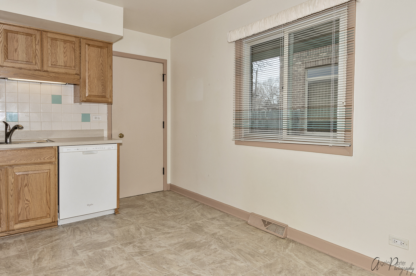 280 Westmere Road Des Plaines, IL 60016 - Photo 5 of 27 a view of a kitchen with white cabinets and a window