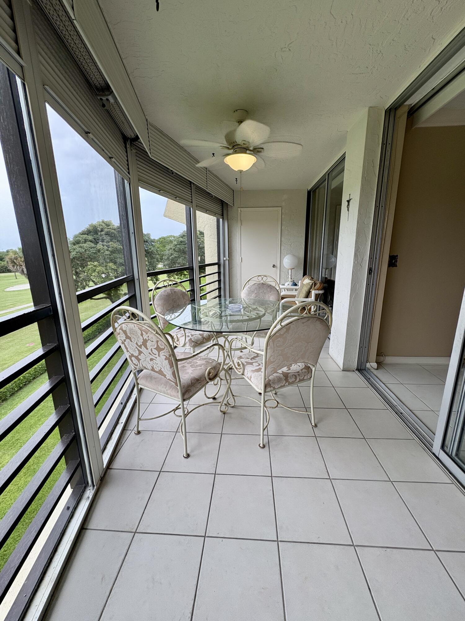 23249 Barwood Lane North, Unit 402 Boca Raton, FL 33428 - Photo 13 of 27 a living room with furniture and a floor to ceiling window