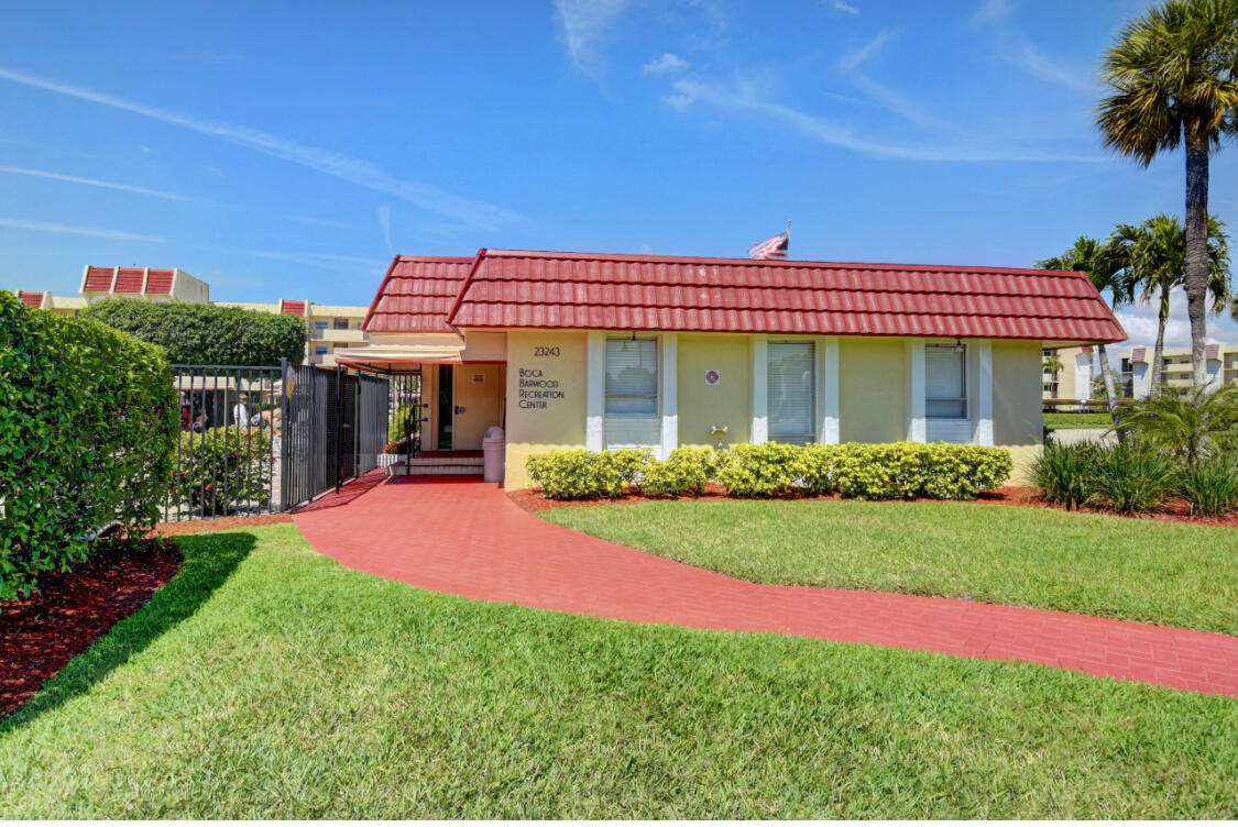 23249 Barwood Lane North, Unit 402 Boca Raton, FL 33428 - Photo 15 of 27 a front view of a house with a yard
