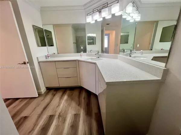 a bathroom with a sink a large mirror and vanity