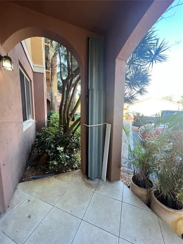 a couple of potted plants in front of a door