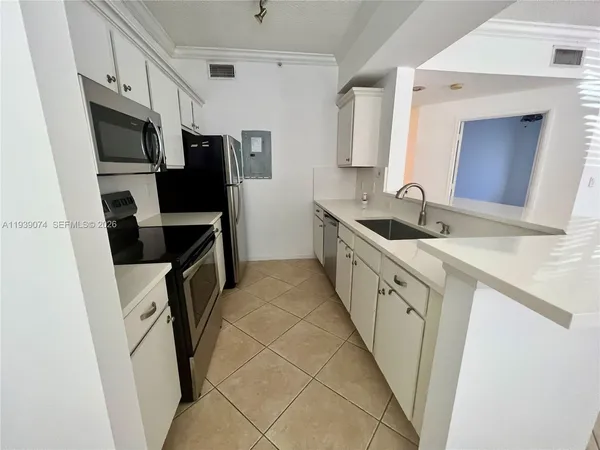 a kitchen with granite countertop a sink stove and refrigerator
