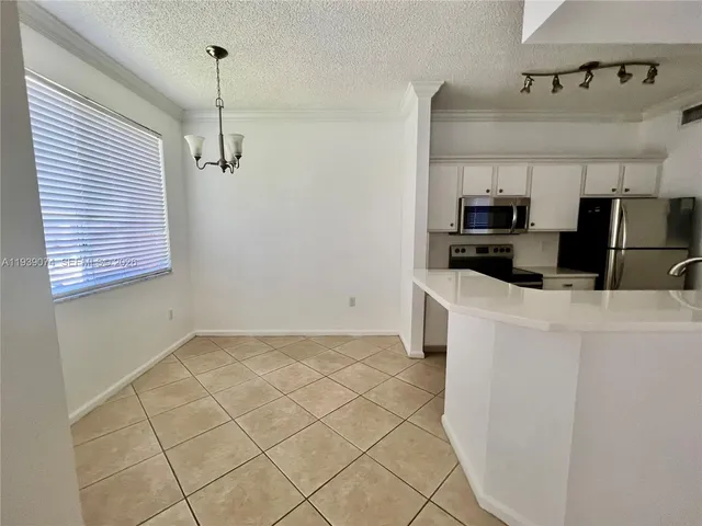 a kitchen with stainless steel appliances a sink a stove a microwave and cabinets