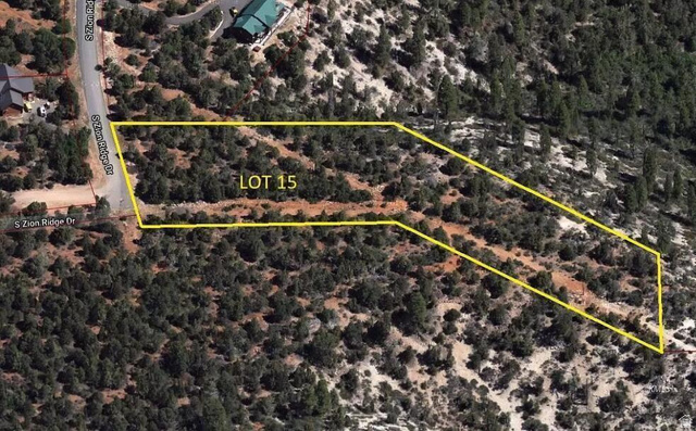 Aerial view of Lot 15, featuring a natural, undeveloped landscape with varied topography