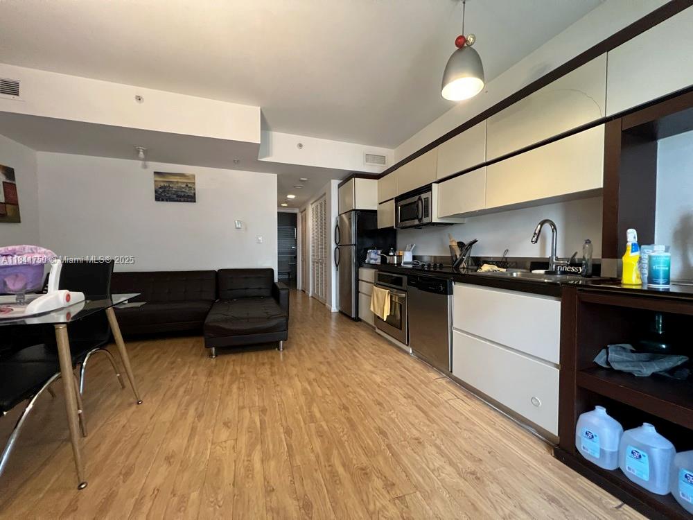 435 21st Street, Unit 116 Miami Beach, FL 33139 - Photo 1 of 7 a kitchen with stainless steel appliances a refrigerator and a stove top oven