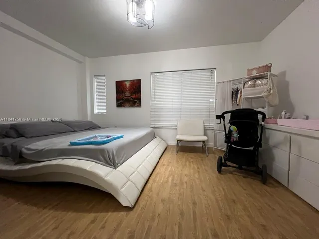 a bedroom with a bed and a chair
