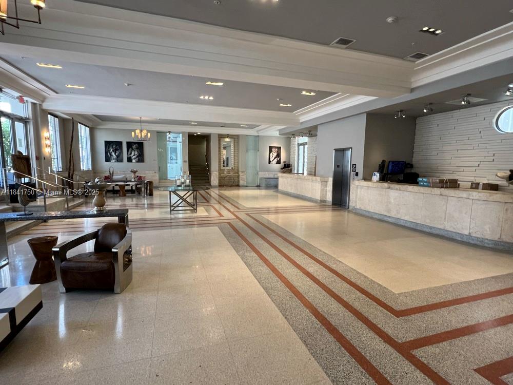 435 21st Street, Unit 116 Miami Beach, FL 33139 - Photo 4 of 7 a large living room with stainless steel appliances furniture a rug and a large window