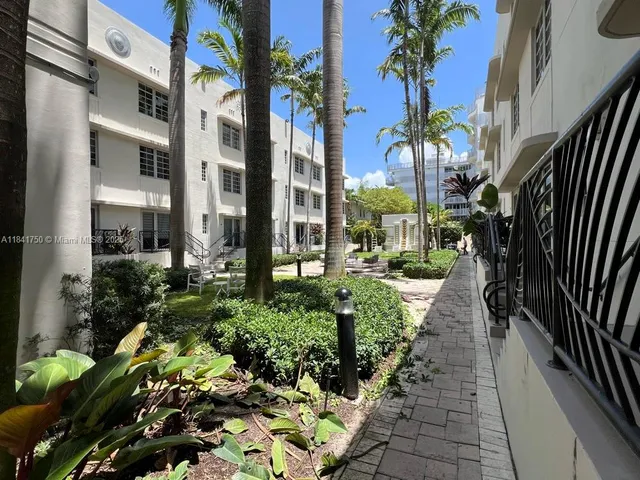 a view of a pathway that has potted plants