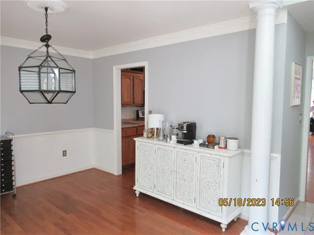 a kitchen with a wooden floor and cabinets