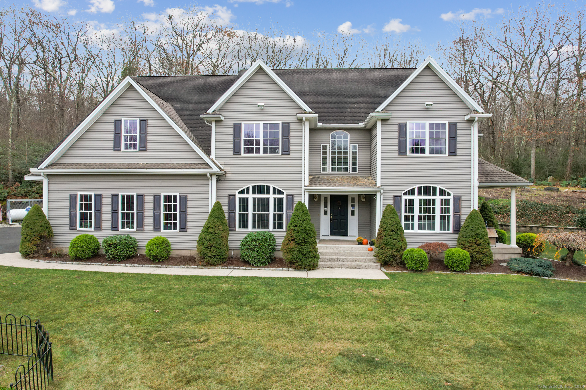 a front view of a house with a yard and porch