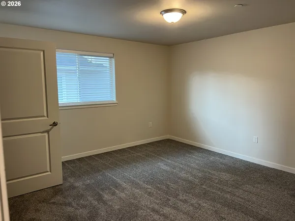 an empty room with a empty space and windows