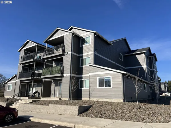a front view of a house with a parking area