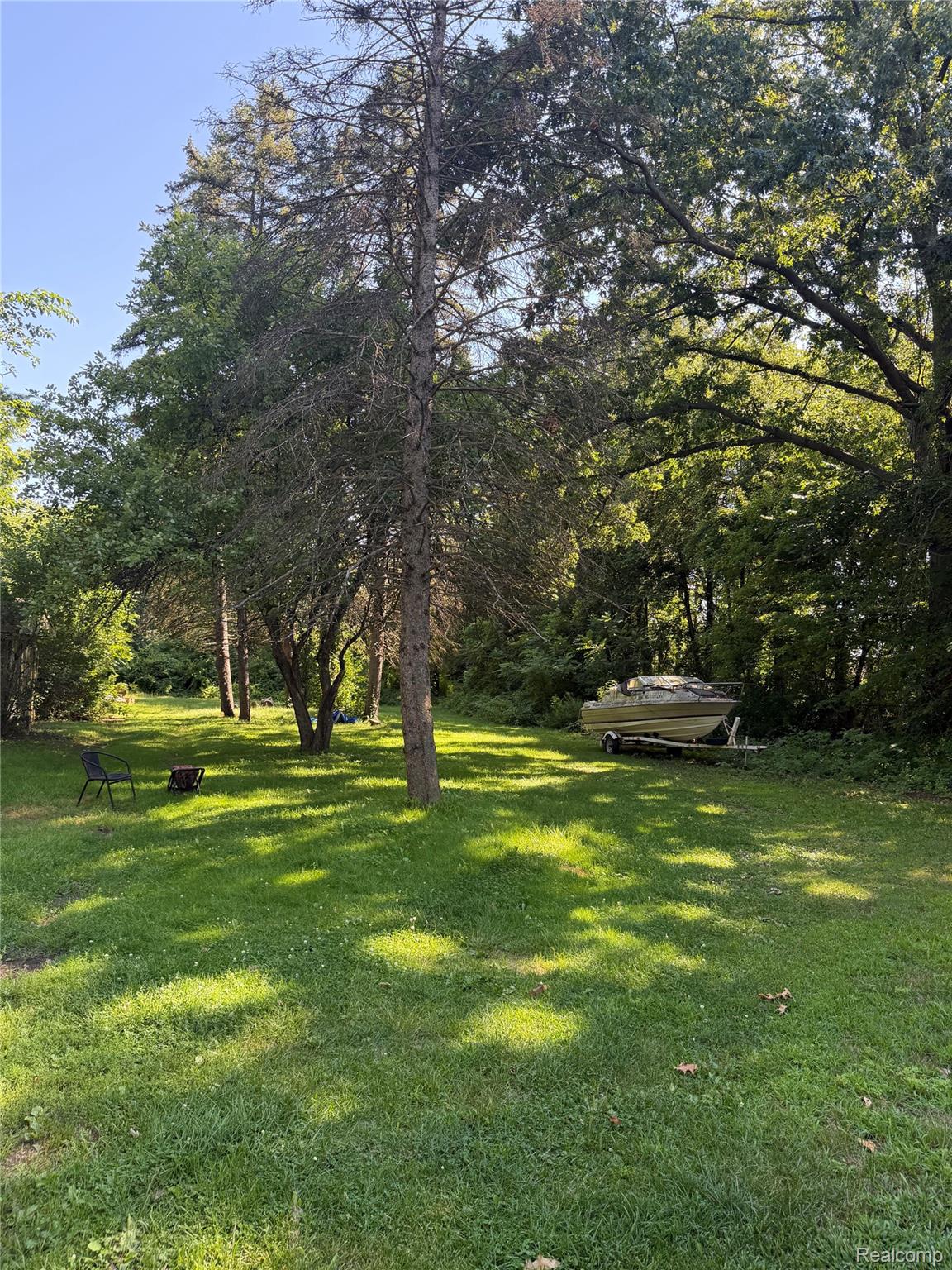 24934 23 Mile Road Macomb, MI 48042 - Photo 20 of 24 Mature tree-lined grounds with expansive, level lawn and natural shade canopy