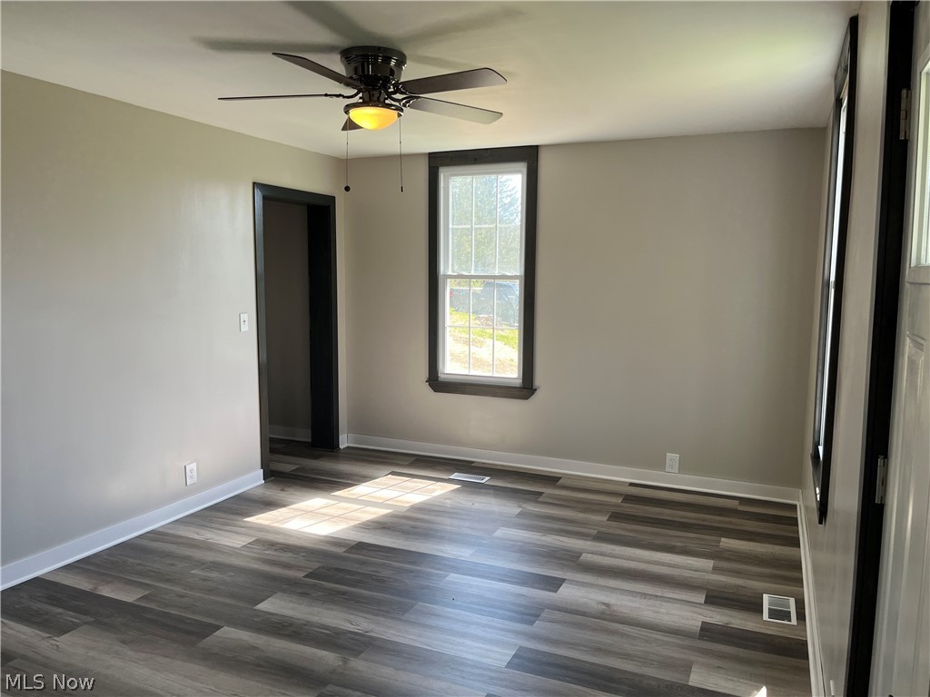 7255 Bagley Road Mount Perry, OH 43760 - Photo 13 of 29 Empty room featuring dark hardwood / wood-style flooring and ceiling fan