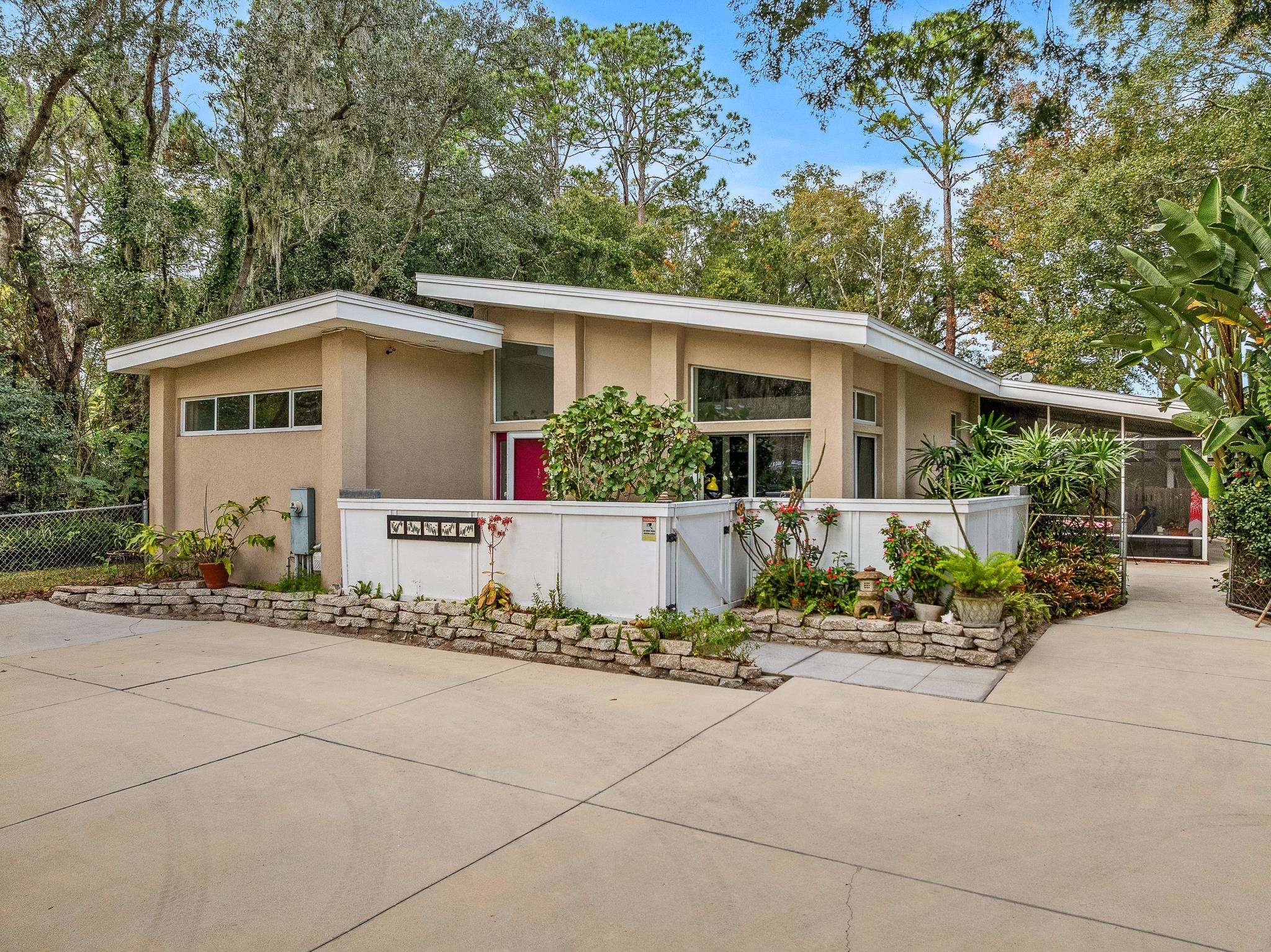 a front view of a house with a garden