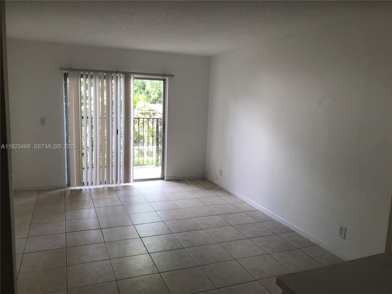 206 Northeast 3rd Street, Unit 10 Hallandale Beach, FL 33009 - Photo 3 of 6 a view of an empty room with a window
