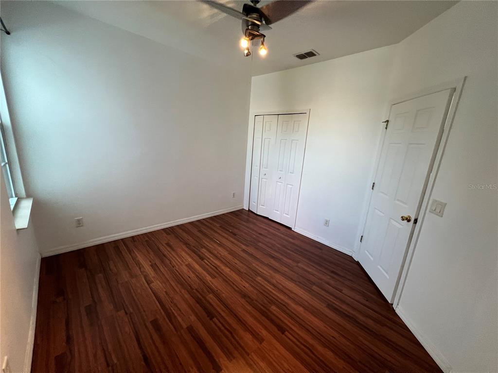 9013 Shepton Street Orlando, FL 32825 - Photo 11 of 20 a view of empty room with wooden floor