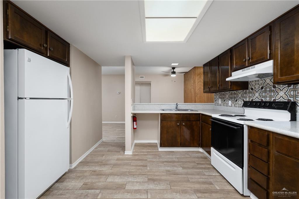 3005 Old Alice Road, Unit 200G Brownsville, TX 78521 - Photo 7 of 21 a kitchen with a sink cabinets stainless steel appliances and a window