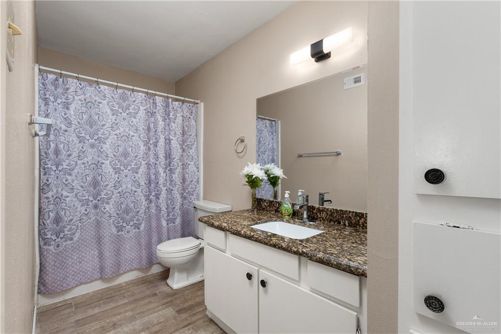 3005 Old Alice Road, Unit 200G Brownsville, TX 78521 - Photo 8 of 21 a bathroom with a granite countertop sink a toilet and shower