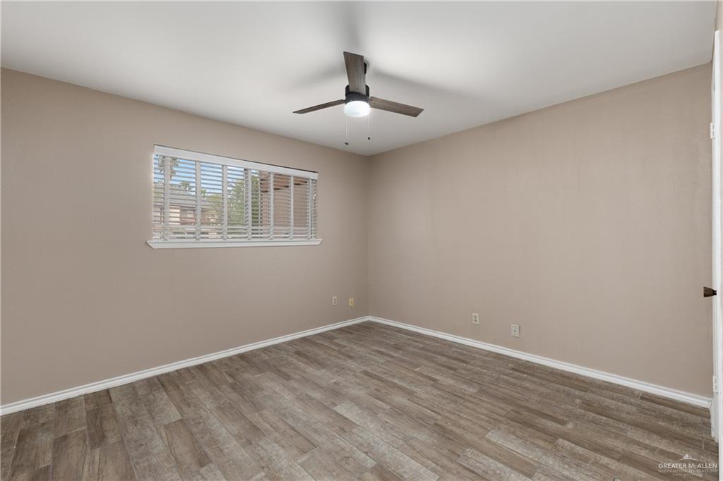 3005 Old Alice Road, Unit 200G Brownsville, TX 78521 - Photo 9 of 21 wooden floor in an empty room with a window