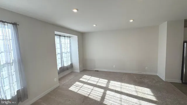 an empty room with windows and closet