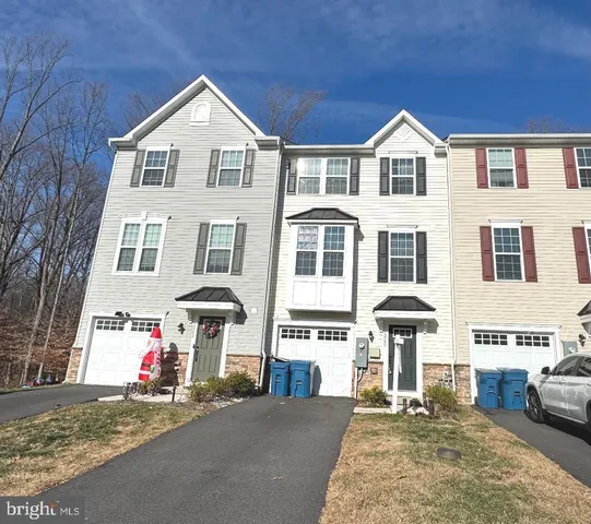 a kitchen with a refrigerator and wooden floor