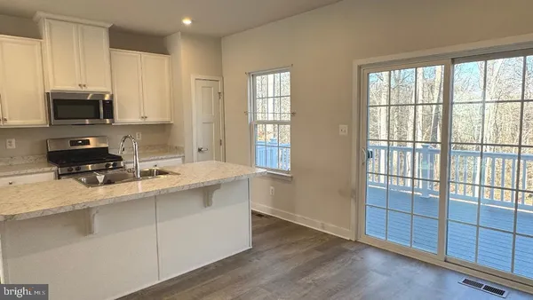 a kitchen with stainless steel appliances a sink stove and cabinets