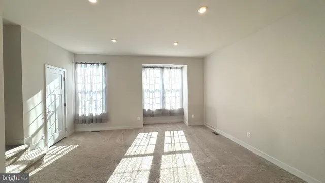 a view of a room with wooden floor and windows