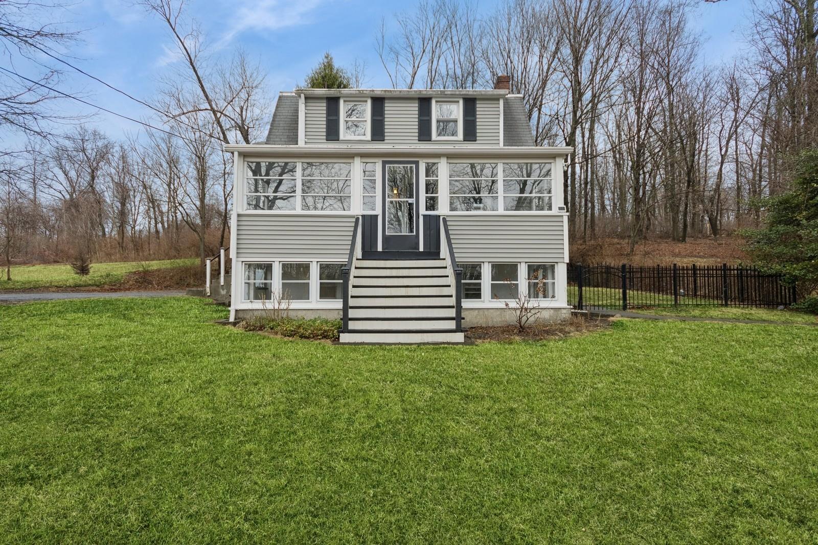 222 Baxtertown Road Fishkill, NY 12524 - Photo 1 of 1 View of front of house with a front lawn, a sunroom, and fence