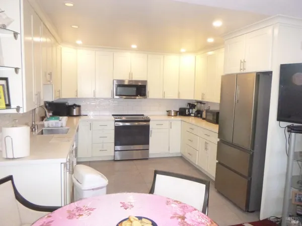 a kitchen with a sink appliances and cabinets
