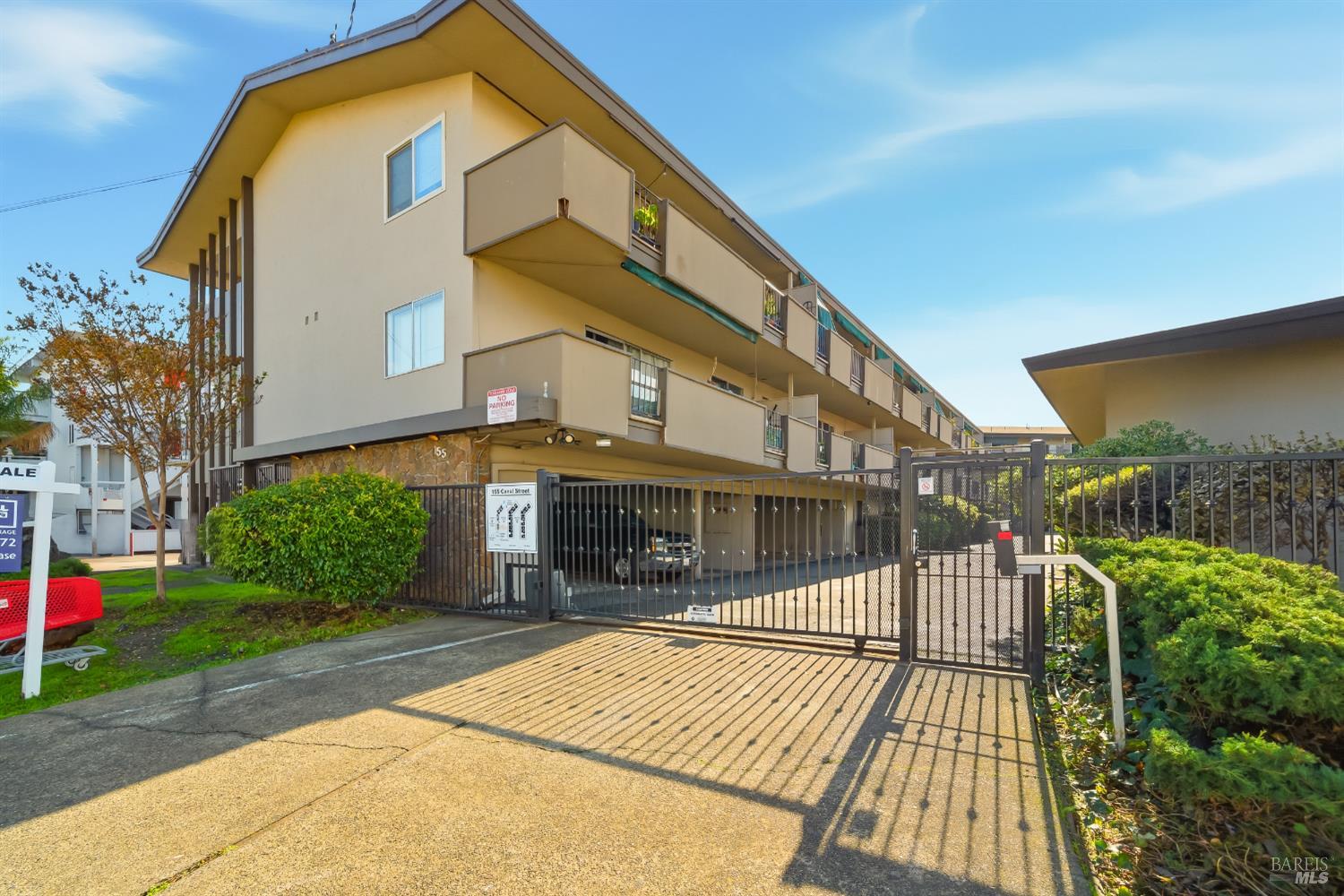 155 Canal Street, Unit 7 San Rafael, CA 94901 - Photo 15 of 17 a view of a building with a yard