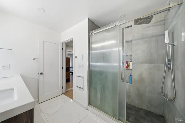 a bathroom with a glass shower door