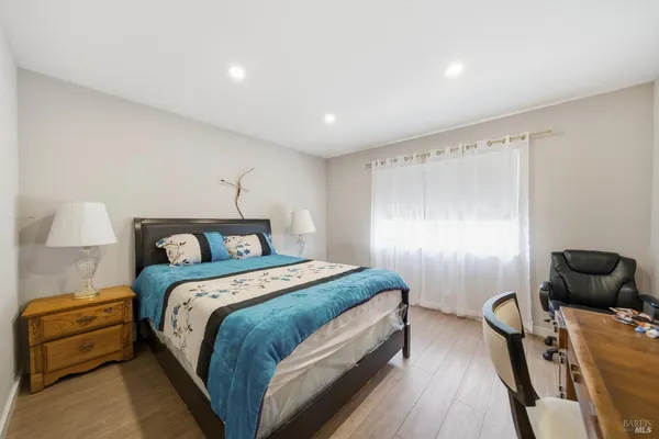 a bedroom with a bed and a lamp