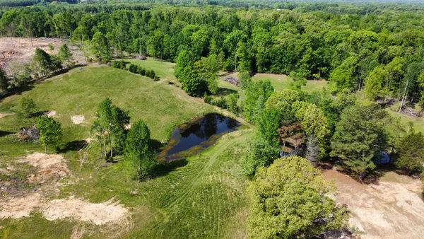 an aerial view of mountains with green space