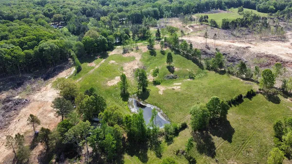 an aerial view of a house with a yard