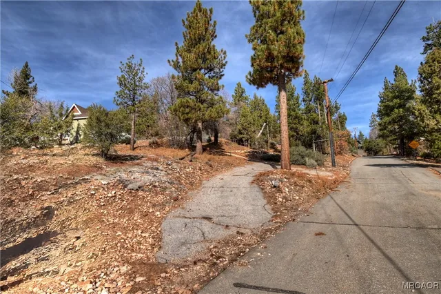 a view of a yard covered with snow on the road