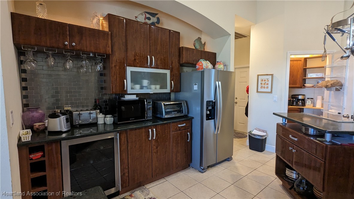 1101 Lakeside Way Sebring, FL 33876 - Photo 13 of 41 a kitchen with a refrigerator and a sink