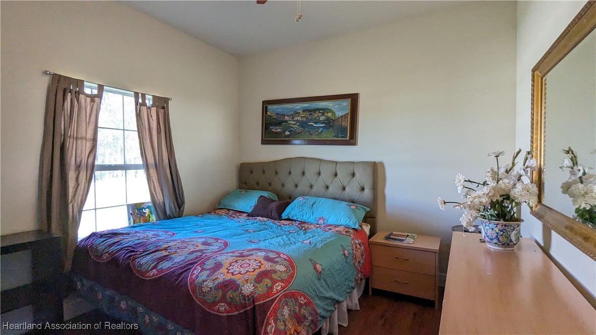 1101 Lakeside Way Sebring, FL 33876 - Photo 17 of 41 a bedroom with a large bed and a potted plant