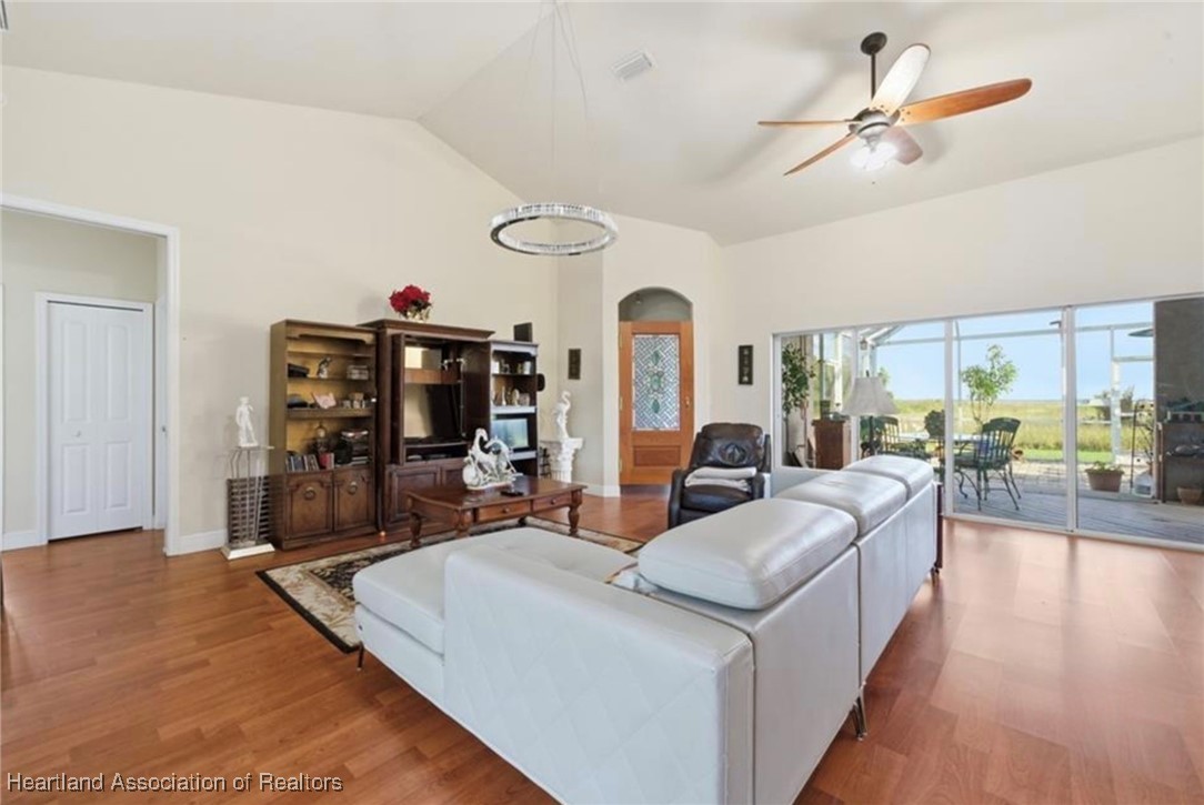 1101 Lakeside Way Sebring, FL 33876 - Photo 22 of 41 a living room with furniture a flat screen tv and a large window