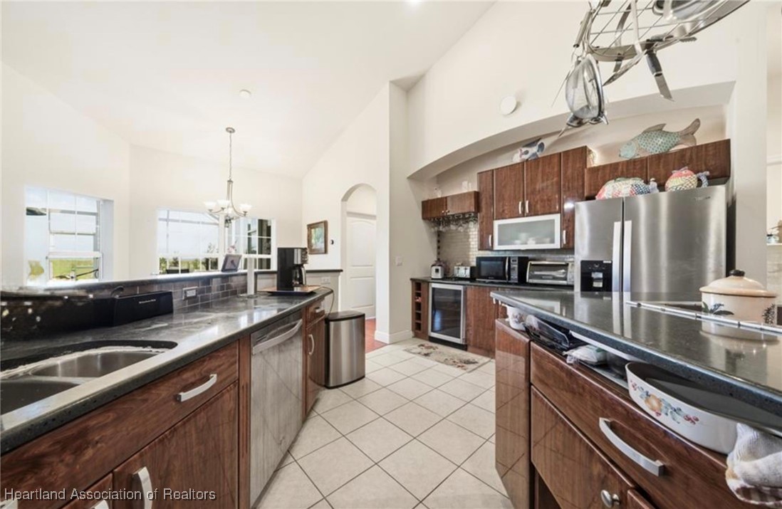 1101 Lakeside Way Sebring, FL 33876 - Photo 25 of 41 a kitchen with stainless steel appliances a sink a stove and a refrigerator