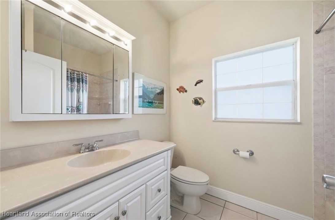 1101 Lakeside Way Sebring, FL 33876 - Photo 27 of 41 a bathroom with a granite countertop sink toilet and mirror