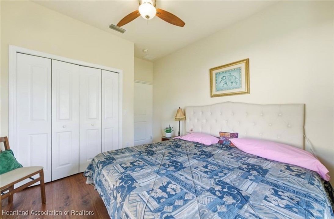 1101 Lakeside Way Sebring, FL 33876 - Photo 31 of 41 a bedroom with a bed and a chandelier