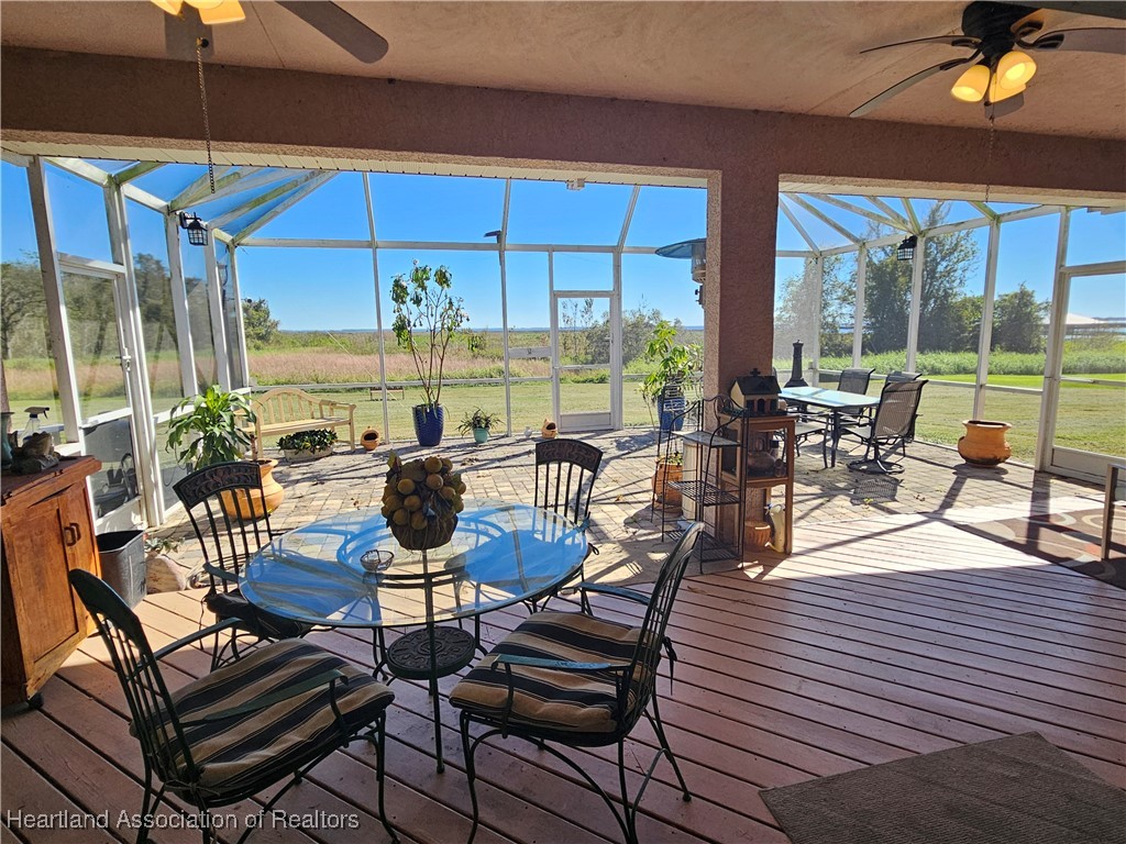 1101 Lakeside Way Sebring, FL 33876 - Photo 35 of 41 a view of a swimming pool with a table and chairs under an umbrella