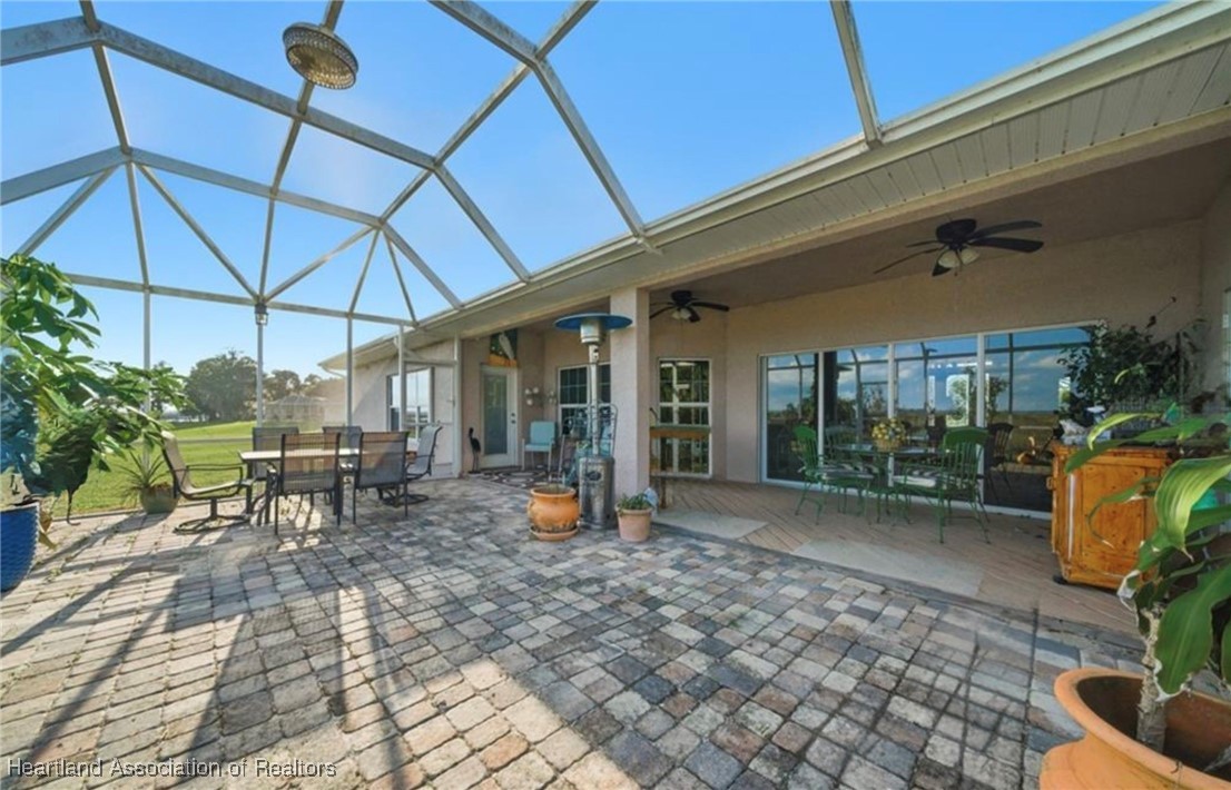 1101 Lakeside Way Sebring, FL 33876 - Photo 39 of 41 a view of a patio with table and chairs under an umbrella