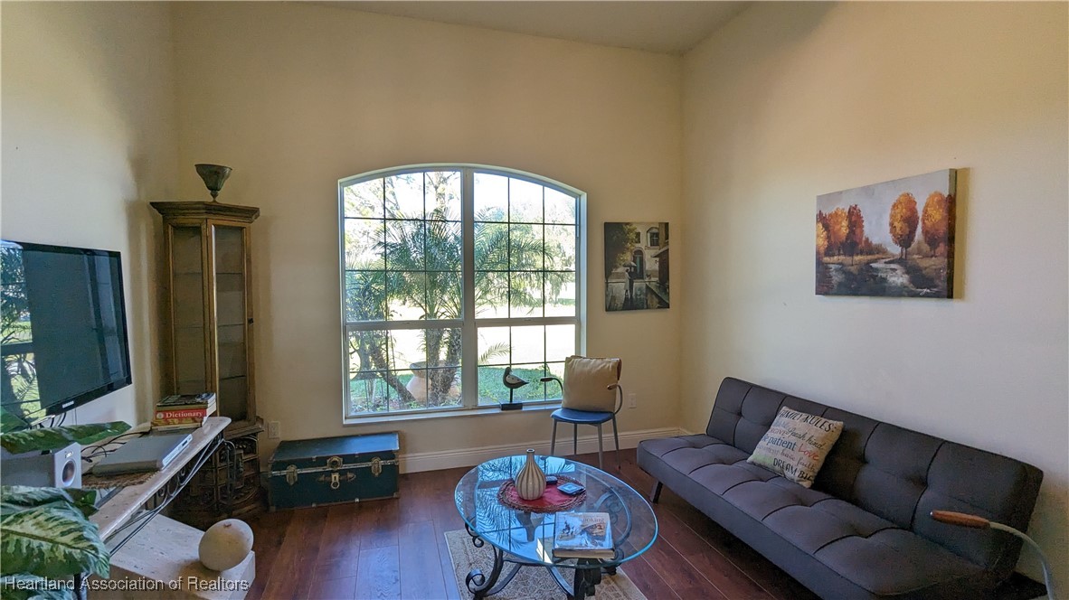 1101 Lakeside Way Sebring, FL 33876 - Photo 5 of 41 a living room with furniture and a flat screen tv with wooden floor