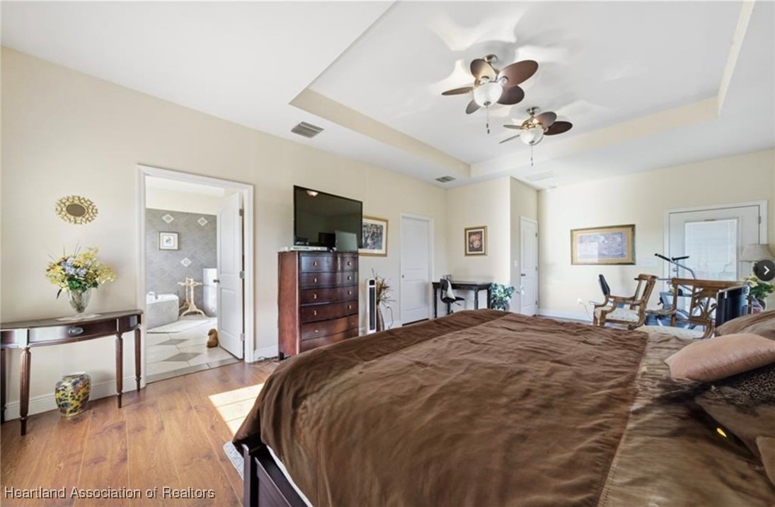 1101 Lakeside Way Sebring, FL 33876 - Photo 7 of 41 a bed room with a bed mirror and a chair